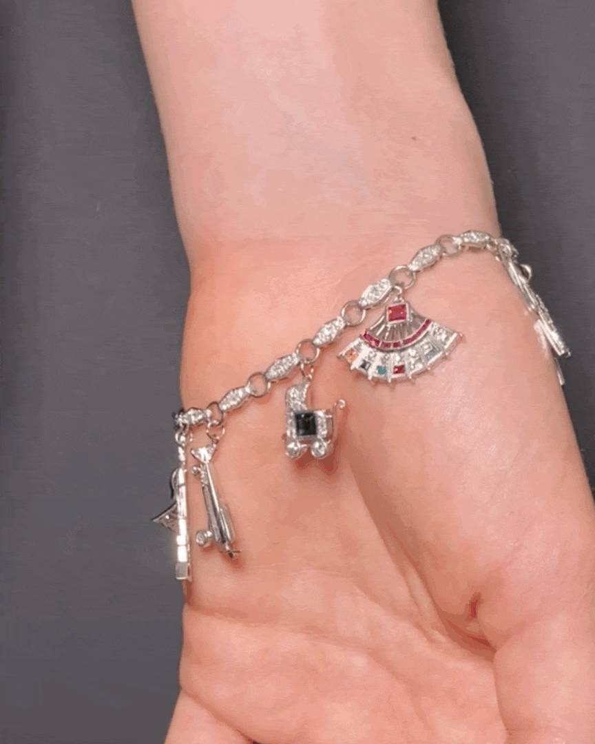 ART DÉCO DIAMOND, COLOURED GEMSTONES & PLATINUM BRACELET WITH 12 CHARMS, INCL. 1 BY CARTIER