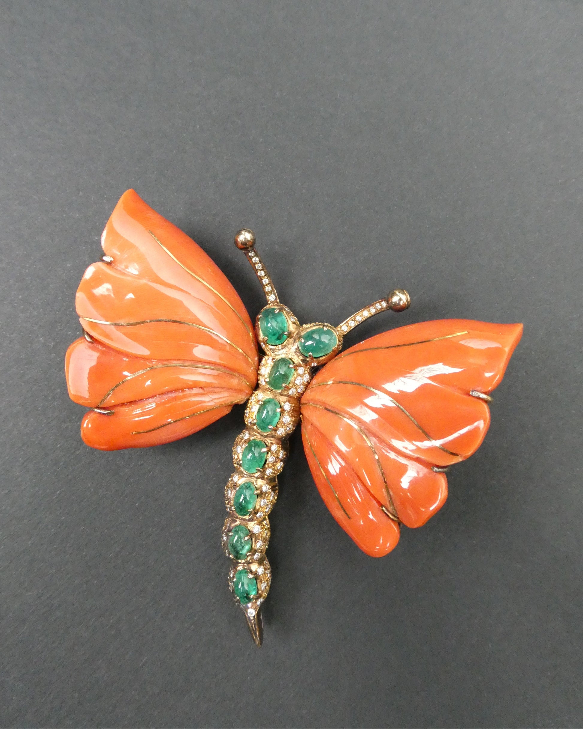 A MONUMENTAL ITALIAN BUTTERFLY BROOCH with eight cabochon emeralds and diamonds over coral