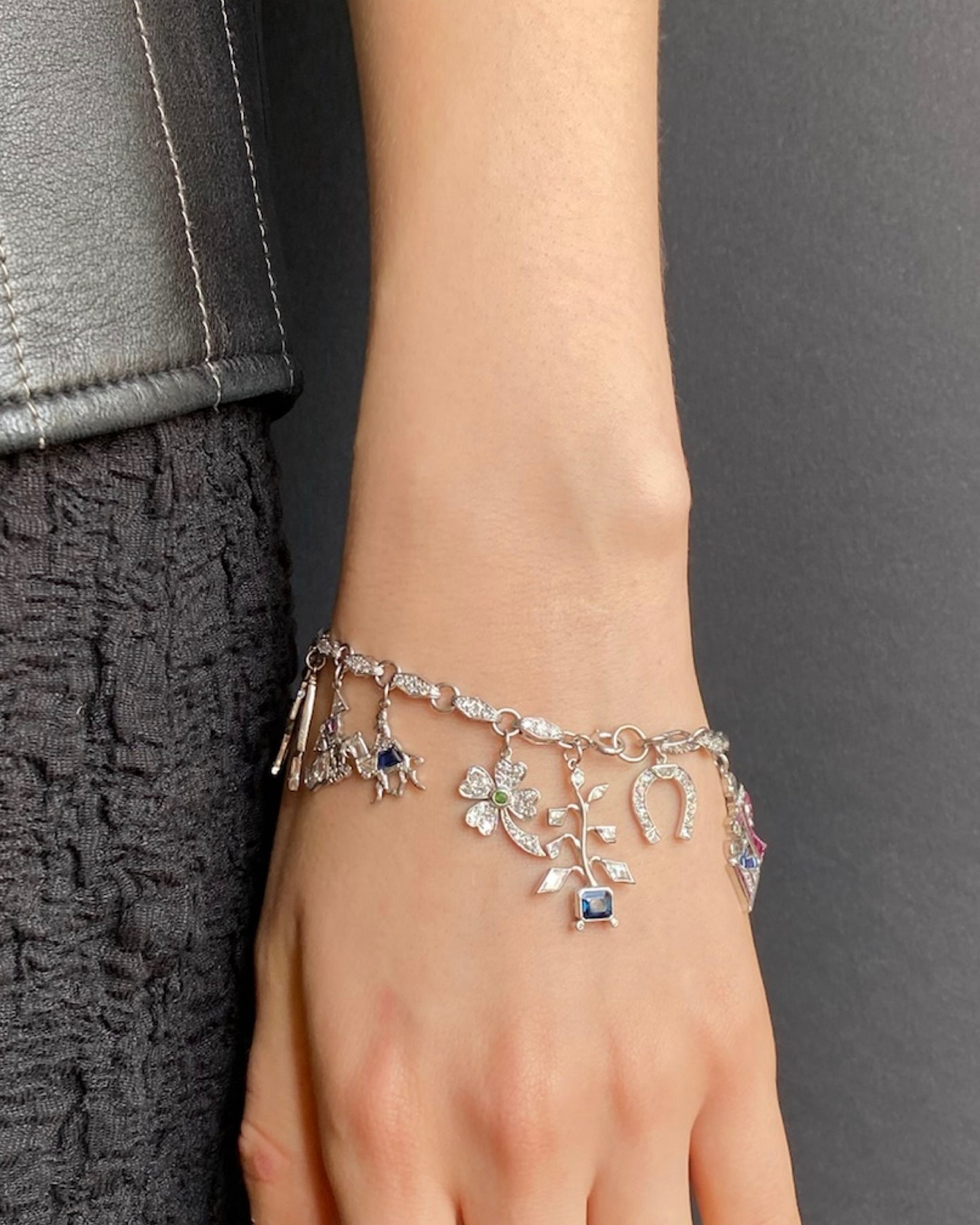 ART DÉCO DIAMOND, COLOURED GEMSTONES & PLATINUM BRACELET WITH 12 CHARMS, INCL. 1 BY CARTIER