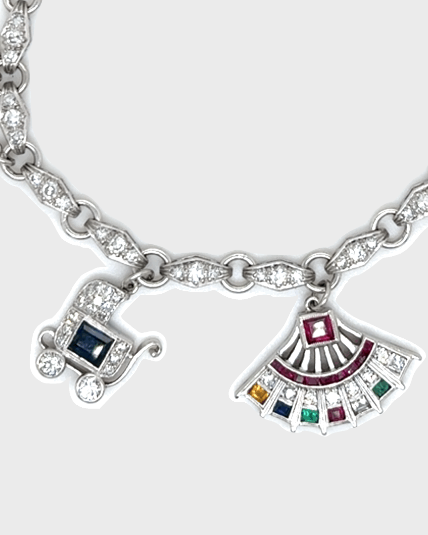 ART DÉCO DIAMOND, COLOURED GEMSTONES & PLATINUM BRACELET WITH 12 CHARMS, INCL. 1 BY CARTIER