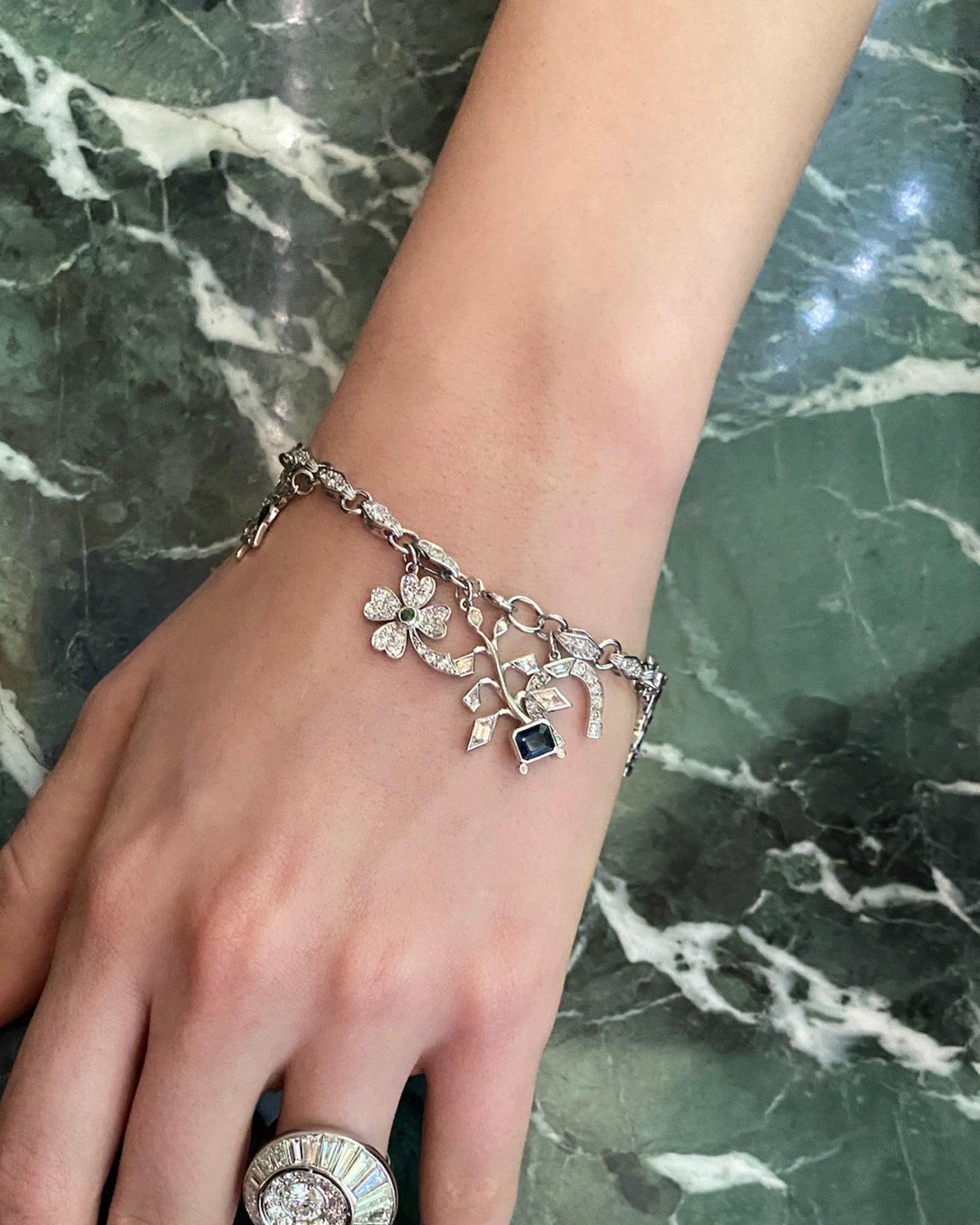 ART DÉCO DIAMOND, COLOURED GEMSTONES & PLATINUM BRACELET WITH 12 CHARMS, INCL. 1 BY CARTIER