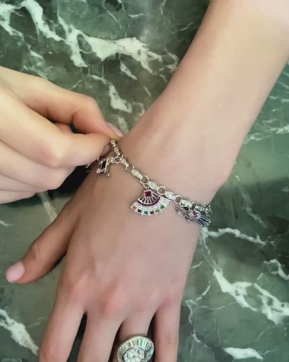 ART DÉCO DIAMOND, COLOURED GEMSTONES & PLATINUM BRACELET WITH 12 CHARMS, INCL. 1 BY CARTIER